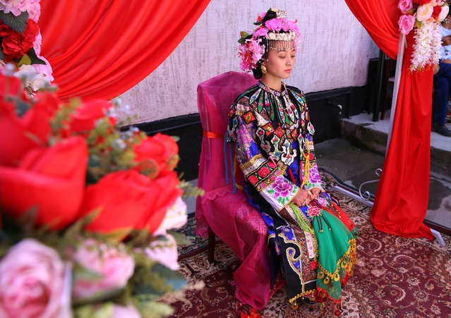 A bride belonging to Kazakhstan's Dungan minority wears hand-embroidered clothing before her wedding in the village of Sortobe on August 27, 2018. (Photo by Petr Trotsenko/Radio Free Europe/Radio Liberty)