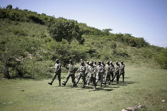Former soldiers and volunteers march during a training day in a makeshift camp in the outskirts of Port-au-Prince, Haiti, October 28, 2015. (Photo by Andres Martinez Casares/Reuters)
