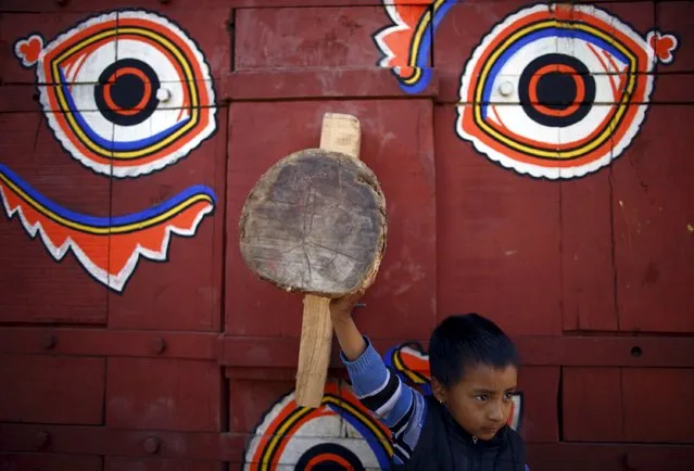 A boy stands in front of the chariot of Hindu god Bhairab before helping to pull the chariot during the Bisket festival at Bhaktapur April 10, 2015. (Photo by Navesh Chitrakar/Reuters)