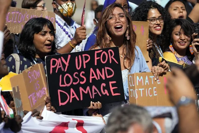 Mitzi Jonelle Tan, of the Philippines, center, participates in a Fridays for Future protest calling for money for climate action at the COP27 U.N. Climate Summit, November 11, 2022, in Sharm el-Sheikh, Egypt. (Photo by Peter Dejong/AP Photo)