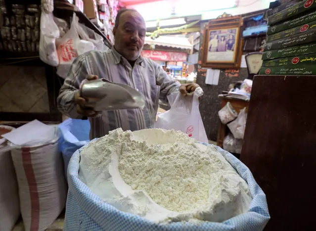 A worker at a herbal store buys flour in Cairo, Egypt January 10, 2017. (Photo by Mohamed Abd El Ghany/Reuters)