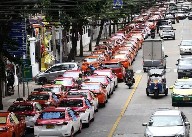 Taxis are parked in the area around the Finance Ministry in Bangkok, Thailand, 27 July 2021. Hundreds of taxi drivers stopped to protest and call on the government to provide assistance and solve problems after the impact of the COVID-19 situation spread to more than 20,000 taxi drivers who do not have access to government assistance. (Photo by Narong Sangnak/EPA/EFE)