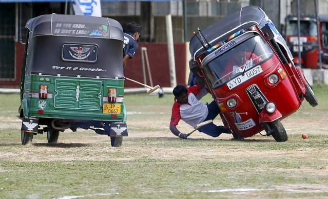 A competitor falls out from his three-wheeled vehicle during a “Tuk Tuk” (Three-Wheeled) Polo game in Galle, Sri Lanka on February 21, 2016. (Photo by Dinuka Liyanawatte/Reuters)