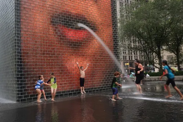 People cool off in Crown Fountain in Millennium Park on August 12, 2021 in Chicago, Illinois. As temperatures climb across the nation, nearly 200 million Americans are under some level of heat advisory. (Photo by Scott Olson/Getty Images)