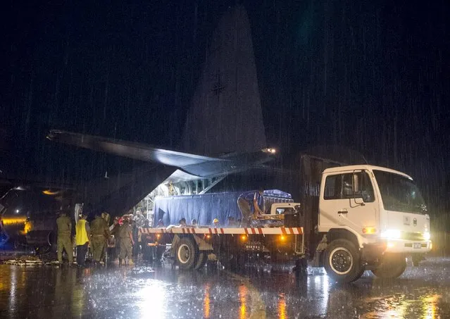Aid supplies including generators, ration packs and water containers are unloaded from a Royal New Zealand Air Force C-130 Hercules aircraft after Cyclone Winston in Suva, Fiji, in this handout image supplied by the New Zealand Defence Force February 23, 2016. (Photo by Reuters/NZ Defence Force)