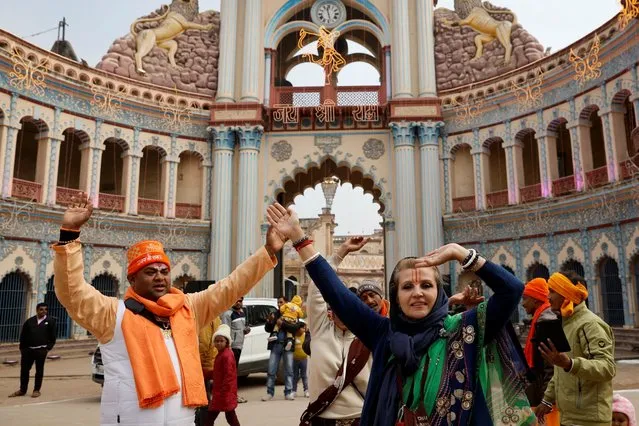 Hindu devotees dance on a street during the inauguration of the Hindu Lord Ram temple in Ayodhya, India on January 22, 2024. (Photo by Adnan Abidi/Reuters)