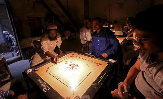 Men play Carrom in a backstreet building in the Old Delhi area of Delhi, India, March 5, 2016. (Photo by Cathal McNaughton/Reuters)