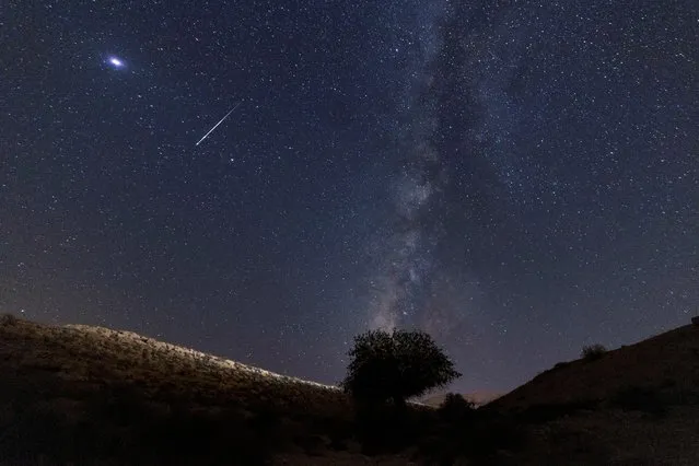 A meteor streaks past stars in the night sky during the annual Perseid meteor shower at the Negev Desert in southern Israel, August 13, 2021. (Photo by Amir Cohen/Reuters)