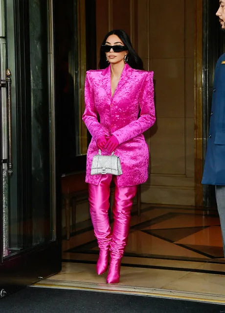 Kim Kardashian exits the Ritz-Carlton hotel on her way to Saturday Night Live rehearsals in New York City on October 7, 2021. The reality TV star carried a Balenciaga bag and wore a hot pink outfit. (Photo by The Image Direct)