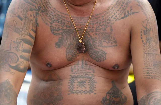 A devotee's tiger tattoo and amulets are pictured during the annual Magic Tattoo Festival at Wat Bang Phra in Nakhon Pathom province, on the outskirts of Bangkok, Thailand, March 19, 2016. (Photo by Chaiwat Subprasom/Reuters)