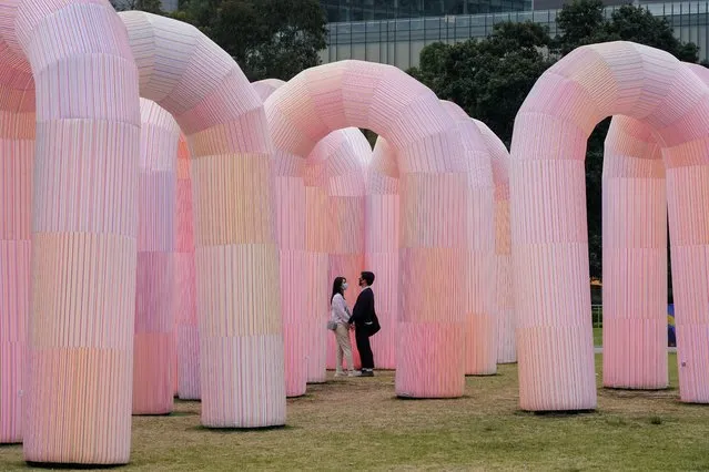 People in protective face masks walk through an interactive art installation in a city centre park, as coronavirus disease (COVID-19) vaccination rates continue to rise, in Sydney, Australia, November 19, 2021. (Photo by Loren Elliott/Reuters)