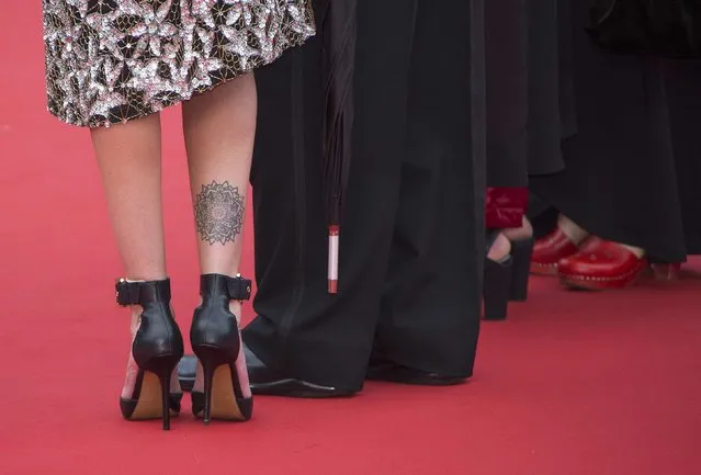 The shoes of an unidentified guest are pictured as she stands on the red carpet during arrivals for the screening of the film “Sicario” in competition at the 68th Cannes Film Festival in Cannes, southern France, May 19, 2015. (Photo by Yves Herman/Reuters)