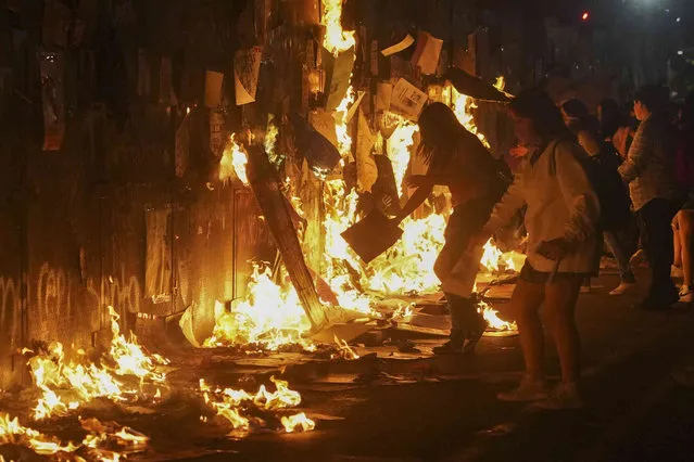 A police barricade that surrounds the National Palace goes up in flames, set on fire by some of the demonstrators who marched to the Zocalo to mark International Women's Day, in Mexico City, Friday, March 8, 2024. (Photo by Aurea del Rosario/AP Photo)