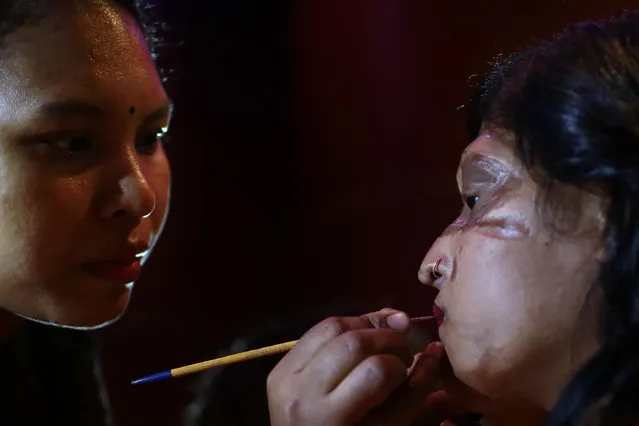 In this March 7, 2017 photo, a Bangladeshi acid attack survivor gets her make up applied during the event “Beauty Redefined” in Dhaka, Bangladesh. (Photo by A.M. Ahad/AP Photo)