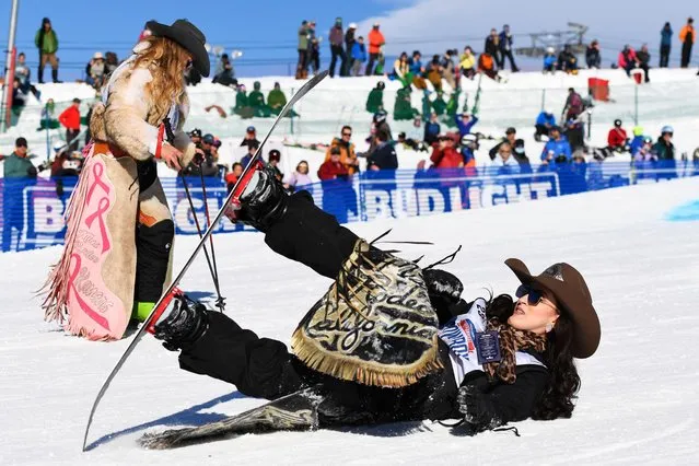 Miss Rodeo Queen California, Jackie Scarry, (R) gets back up after crashing in front of a fellow competitor in the slalom course during the 47th Annual Cowboy Downhill on January 17, 2022 at Steamboat Ski Resort in Steamboat Springs, Colorado. The event started more than 40 years ago when Olympic skier Billy Kidd invited a few of the ProRodeo starts to Steamboat for a day of skiing. (Photo by Jason Connolly/AFP)