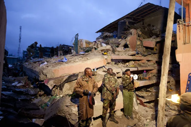 Kenyan police officers stand guard at the site of a building collapse in Nairobi, Kenya, Saturday, April 30, 2016. (Photo by Sayyid Abdul Azim/AP Photo)
