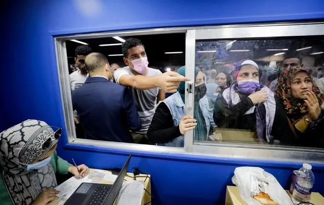People wait to receive a dose of the coronavirus disease (COVID-19) vaccine at an immediate vaccination center operating at the Sadat underground metro station, in Cairo, Egypt, November 14, 2021. (Photo by Mohamed Abd El Ghany/Reuters)