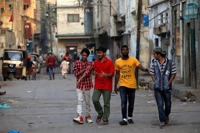 Lyari UnderGround (L.U.G) rappers, (from L) Killa, Abood, Slipknot Denna and Danger, walk in an alley at Lyari area in Karachi, Pakistan February 1, 2017. (Photo by Akhtar Soomro/Reuters)