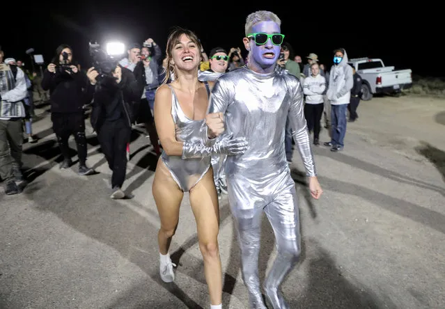People dressed in costumes chant as they approach a gate to Area 51 as an influx of tourists responding to a call to “storm” Area 51, a secretive U.S. military base believed by UFO enthusiasts to hold government secrets about extra-terrestrials, is expected in Rachel, Nevada, U.S. September 20, 2019. (Photo by Jim Urquhart/Reuters)