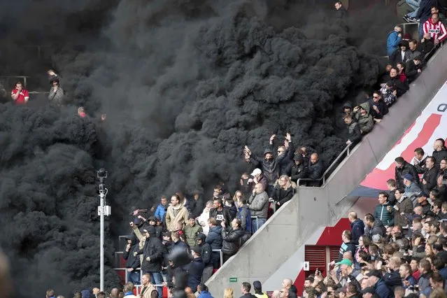 Black smoke engulfs the tribune during the PSV Eindhoven vs Ajax KNVB Cup football match in Eindhoven on April 23, 2017. (Photo by Marcel van Hoorn/AFP Photo/ANP)