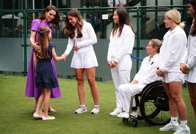 Catherine, Princess of Wales (2nd L) and Princess Charlotte (2nd L) meet Flora Johnson (C) during a visit to the All England Lawn Tennis and Croquet Club in Wimbledon, south west London, on day fourteen of the Wimbledon Tennis Championships on July 14, 2024 in London, England. The Princess of Wales will present the trophy to the winner of the men's final. (Photo by Aaron Chown – WPA Pool/Getty Images)