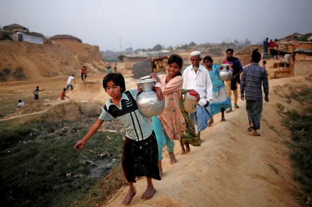 Rohingya refugee girls carry drinking water at Kutupalang Unregistered Refugee Camp, in Cox’s Bazar, Bangladesh, February 10, 2017. (Photo by Mohammad Ponir Hossain/Reuters)