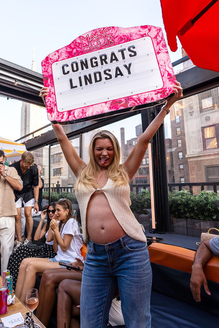 American TV personality Lindsay Hubbard holds a sign at Magic Hour Rooftop Bar in the second decade of July 2024. (Photo by Jared Sugar/Tao Group Hospitali)