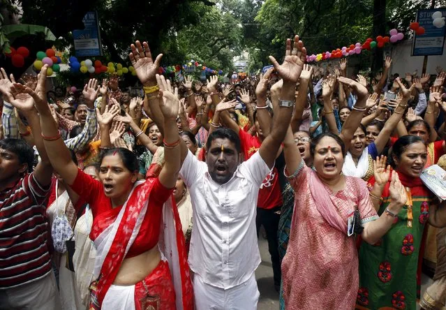 Hindu devotees raise their hands and shout religious slogans during the annual Rath Yatra, or chariot procession, in Kolkata, India, July 18, 2015. (Photo by Rupak De Chowdhuri/Reuters)