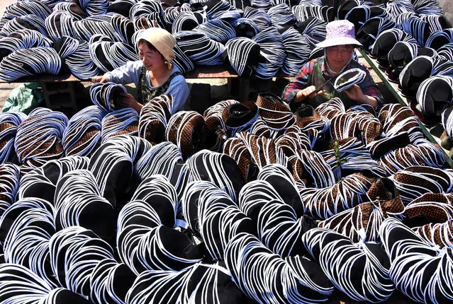 Employees work on traditional cloth shoes in Yiyuan County, Shandong province, China, May 2, 2017. (Photo by Reuters/Stringer)