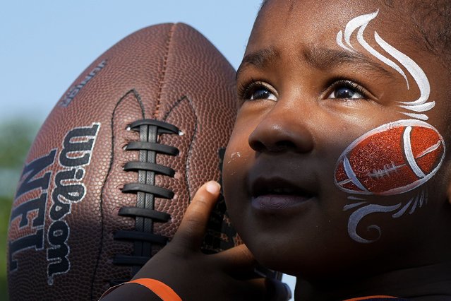 Ros'e Prince, 3, from Chicago, looks at the target before she prepares to throw a ball in the Chicago Bears Fans Zone during an NFL football training camp practice in Lake Forest, Ill., Saturday, July 27, 2024. (Photo by Nam Y. Huh/AP Photo)