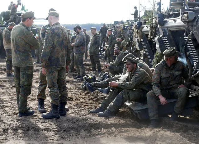 German army soldiers rest after NATO enchanced Forward Presence Battle Group Lithuania exercise in Pabrade military training field, Lithuania, May 17, 2017. (Photo by Ints Kalnins/Reuters)