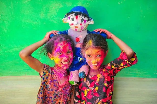 Bangladeshi children from Khan Tea garden posing for photos on March 23, 2022 with their faces painted after adorning with colors like Rainbows on the celebration of the annual Hindu festival of colors, known as Holi festival marking the onset of spring. (Photo by Md Rafayat Haque Khan/Eyepix Group/Rex Features/Shutterstock)