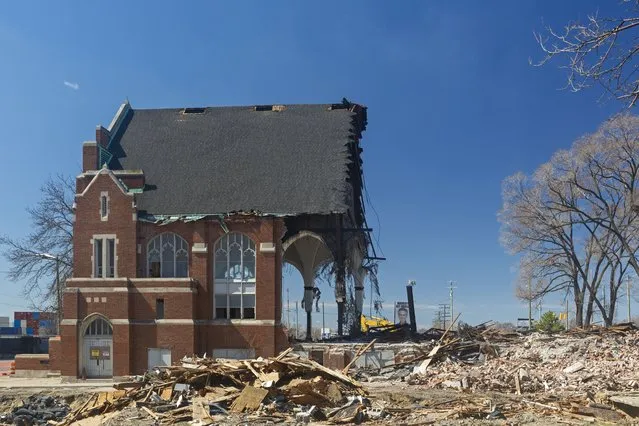 The 100-year-old All Saints Catholic Church is being demolished in Michigan on April 10, 2022. The Archdiocese of Detroit closed the church in 2017, merging its congregation with nearby St. Gabriel parish. Declining attendance at All Saints was partly due to a fear of immigration raids in the surrounding Hispanic community. (Photo by Jim West/ZUMA Press Wire/Rex Features/Shutterstock)
