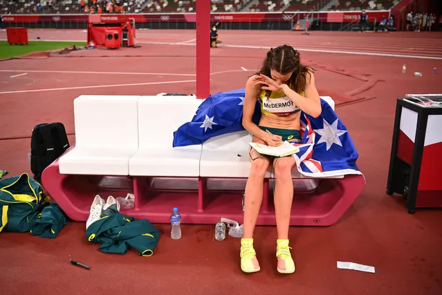 Silver medallist Australia's Nicola McDermott writes in a notebook after the women's high jump final during the Tokyo 2020 Olympic Games at the Olympic Stadium in Tokyo on August 7, 2021. (Photo by Dylan Martinez/Reuters)