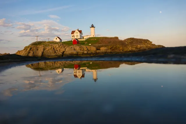 “Nubble in a Puddle”. While in Maine I made a point of visiting several lighthouses. This is Nubble Light – Cape Neddick Lighthouse shot from Sohier Park. The sun was going down behind me so I was about to lose the light. There were several puddles down on the rocks left behind from from high tide so I jumped down, put the camera on the ground and took a shot. Photo location: Cape Neddick Lighthouse, Sohier Park, Maine. (Photo and caption by Christopher V. Sherman/National Geographic Photo Contest)