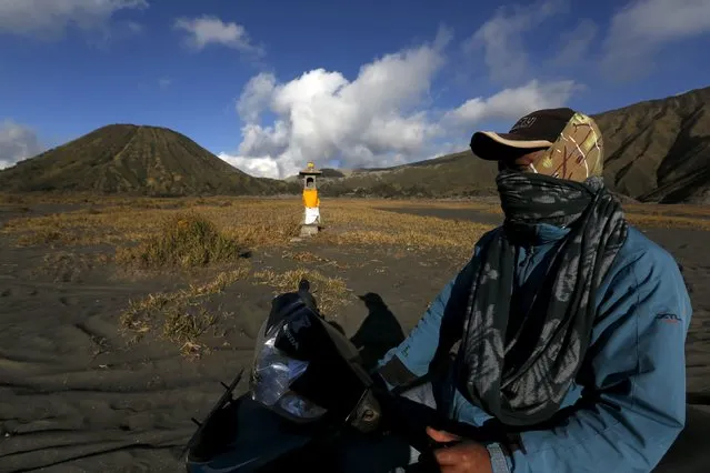 A Hindu villager rides a motorcycle past an altar ahead of the annual Kasada festival at the Mount Bromo in Indonesia's East Java province, July 30, 2015. (Photo by Reuters/Beawiharta)