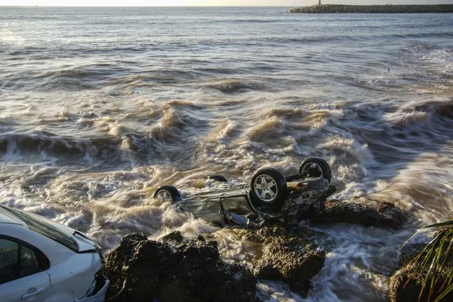 Wrecked cars stuck in the rocky shore of the seaside town of Alcanar, in northeastern Spain, Thursday, September 2, 2021. A downpour Wednesday created flash floods that swept cars down streets in the Catalan town of Alcanar. Most of mainland Spain is under alert for heavy rains. (Photo by Joan Mateu Parra/AP Photo)