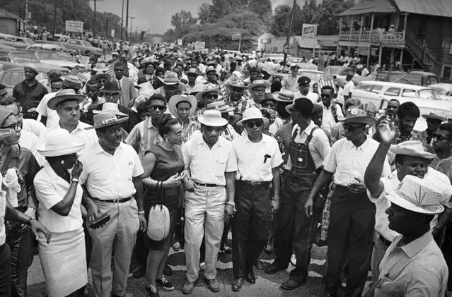 Thousands of civil rights marchers fall in behind their leaders as the last leg of the Mississippi March sets out from Tougaloo College for Jackson in Tougaloo, Mississippi on Sunday, June 26, 1966. In the front row left to right are: the Rev.  Ralph Abernathy, Juanita Abernathy, Mrs. Coretta Scott King,  Dr. Martin Luther King, James Meredith, Stokely Carmichael of the Student Non-Violent Coordinating Committee (looking back) and Floyd B. McKissick, national director of the Congress of Racial Equality. (Photo by Charles Kelly/AP Photo)
