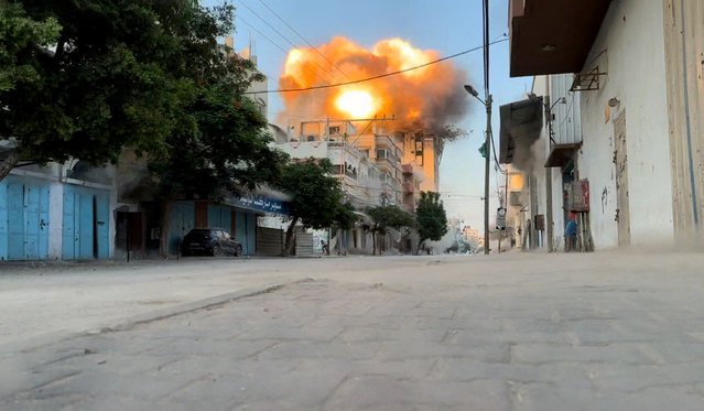 Smoke and flames rise following an Israeli strike on a residential building, amid the ongoing conflict between Israel and Hamas, Nuseirat in the central Gaza Strip, in this screen grab taken from a video on August 18, 2024. (Photo by Reuters TV)