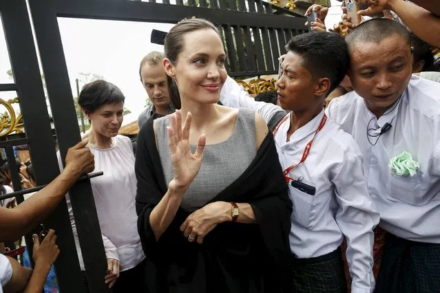 Myanmar pro-democracy leader Aung San Suu Kyi (not pictured) and UNHCR special envoy Angelina Jolie Pitt leave after visiting a hostel for female factory workers in the Hlaingtaryar Industrial Zone in Yangon August 1, 2015. (Photo by Soe Zeya Tun/Reuters)