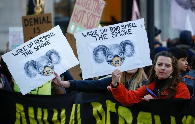 Protesters hold banners as they demonstrate against the Australian government's inaction over climate change despite the bushfires crisis, outside the Australian Embassy in London, Britain, January 10, 2020. (Photo by Henry Nicholls/Reuters)
