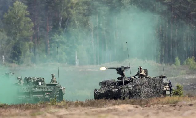 Members of the U.S. Army take part in a military exercise “Iron Wolf 2016” at the Training Range in Pabrade some 60km (38 miles) north of the capital Vilnius,, Lithuania, Thursday, June 16, 2016. Iron Wolf 2016, the part of the annual multinational Exercise Saber Strike held in Lithuania, is running in June in Rukla and Pabrade, two training areas of the Lithuanian Armed Forces. In total, over 5 thousand soldiers from 7 NATO allies are training at the same time in Lithuania this year. (Photo by Mindaugas Kulbis/AP Photo)