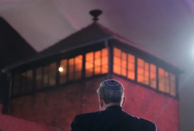 A man wearing a yarmulka stands next to the main tower at the entrance to the former Auschwitz-Birkenau concentration camp, which is covered under a large tent, prior to the official ceremony to mark the 75th anniversary of the liberation of the camp on January 27, 2020 near Oswiecim, Poland. International leaders as well as approximately 200 survivors and their families are gathering at Auschwitz today to attend the commemoration. The Nazis killed an estimated one million people at the camp during the World War II occupation of Poland by Nazi Germany. The Soviet Army liberated the camp on January 27, 1945. (Photo by Sean Gallup/Getty Images)