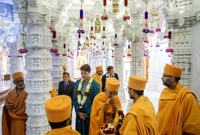 Canada's Prime Minister Justin Trudeau, center, and Toronto Mayor John Tory, right, visit the BAPS Shri Swaminarayan Mandir to celebrate the 10th anniversary of the Hindu temple in Mississauga, Ontario, Saturday July 22, 2017. (Photo by Mark Blinch/The Canadian Press via AP Photo)
