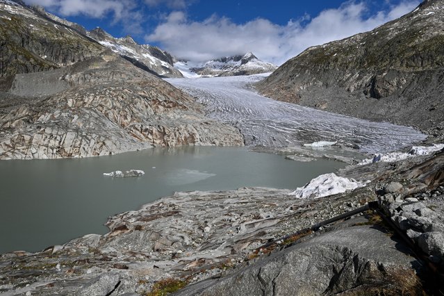 This photograph shows the Rhone Glacier and its glacial lake, formed by the melting of the glacier, above Gletsch, in the Swiss Alps, on September 30, 2024. A snowy winter provided no respite for Switzerland's glaciers, which shed 2.4 percent of their volume over the past year, with sand blown in from the Sahara accelerating the summer melt. The past 12 months have been “exceptional both in terms of accumulation and melt” for the Swiss glaciers, a fresh study from Glacier Monitoring in Switzerland (GLAMOS) showed on October 1, 2024. (Photo by Fabrice Coffrini/AFP Photo)