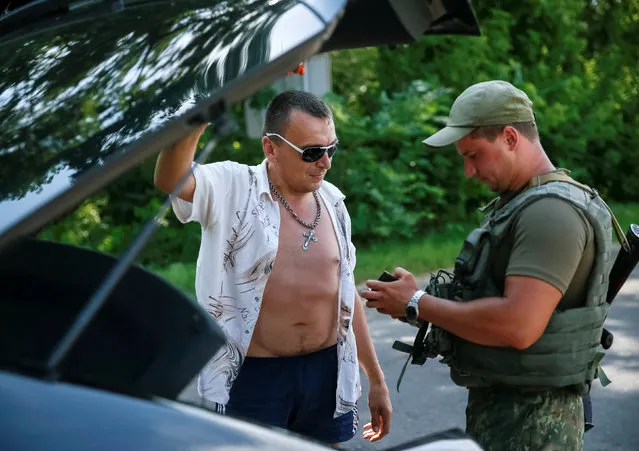 A Ukrainian serviceman checks documents at a checkpoint near Slaviansk, in Donetsk region, Ukraine, June 29, 2016. (Photo by Gleb Garanich/Reuters)