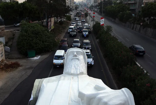 A picture taken on August 20, 2017, shows a statue of Lebanese Christian Maronite monk Saint Charbel, weighing 40 tons and measuring 23 meters, being transported on the Jounieh highway to the town of Faraya north east of Beirut. Saint Charbel Makhlouf, (May 8, 1828 – December 24, 1898) was a Maronite monk and priest who obtained a wide reputation for holiness during his life and was canonized by the Catholic Church. (Photo by Patrick Baz/AFP Photo)