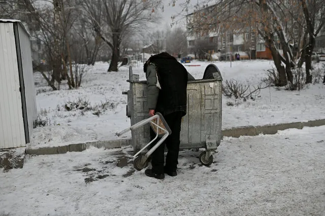 Bystrushkin, who is visually impaired and homeless, looks through a rubbish bin in Omsk, Russia, November 28, 2019. (Photo by Alexey Malgavko/Reuters)