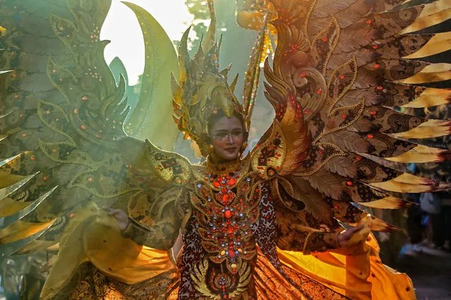 A model performs a costume during a Batik carnival as part of the G20 cultural event, in Solo on July 7, 2022. (Photo by Devi Rahman/AFP Photo)