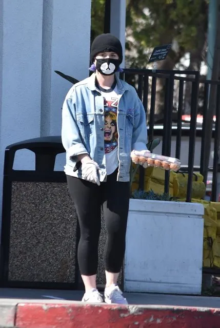 Kelly Osbourne stepped out for a short trip to the market this afternoon, only to walk out with just a dozen eggs in Los angeles, CA. on March 26, 2020. Kelly used precaution using a face mask and wore latex gloves for her safety. Ozzy's daughter was seen sporting an OZZY FOR PRESIDENT t-shirt with the iconic singer's image on it. (Photo by Backgrid USA)